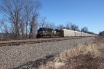 NS 1107 takes a string of autoracks west at MP 116